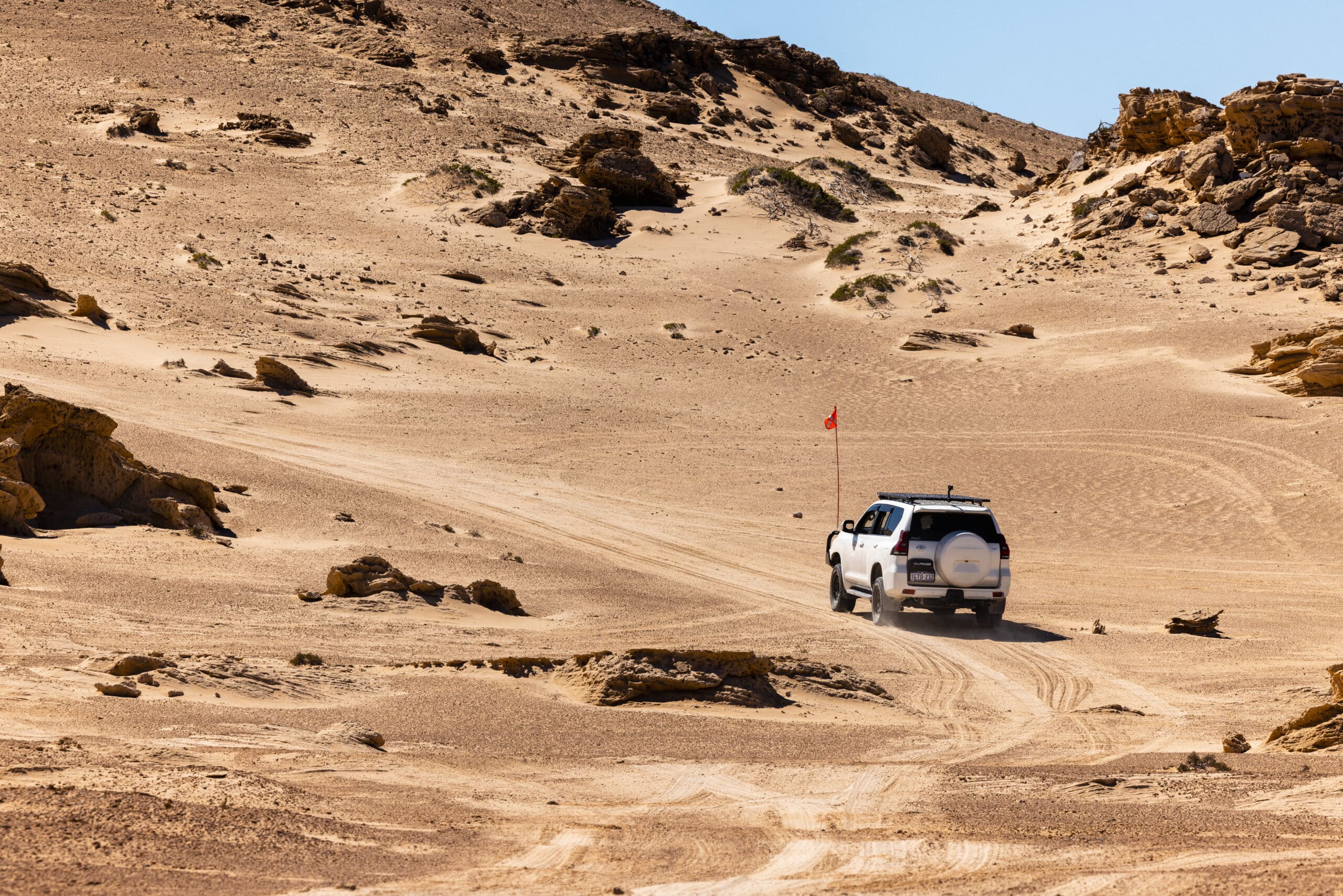 4WD’ing adventure near Coral Bay, Western Australia, with turquoise waters and pristine beaches in the background, a must-see stop on the Perth to Exmouth road trip